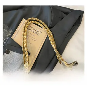 Detail of golden braided handle and shimmering sequins on a luxury hobo tote bag