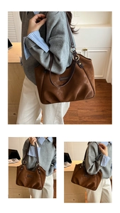 Close-up of brown suede tote bag featuring leather straps and golden metal rings