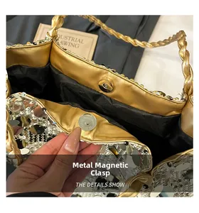 Detailed macro view of the secure golden magnetic snap closure on a sequined tote bag