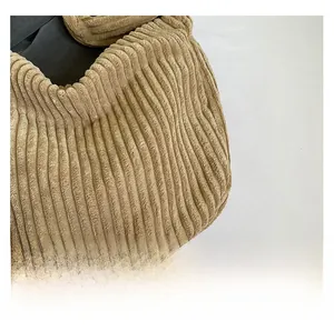 Close-up of premium khaki corduroy fabric texture on a large capacity tote bag