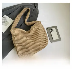 Detail of khaki corduroy tote bag showing soft ribbed texture and casual slouchy design
