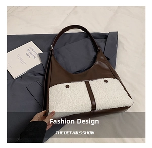 Close-up of retro color-block tote with brown leather and white fleece pockets