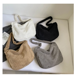 Detailed overhead view showing texture of four colored corduroy hobo shoulder bags