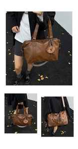 Close-up of deep brown tote bag with woven shoulder strap and donut plush charm accessory