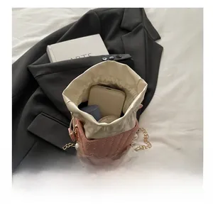 Pink woven bucket bag interior showing capacity for phone, lipstick, and makeup
