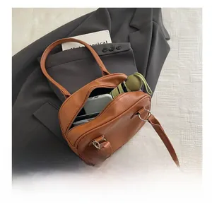 Brown lychee leather handbag showing interior capacity for phone and wallet