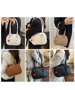 Detail shots of various colors of minimalist litchi pattern bags with heart tags