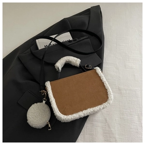 Detailed top view of brown suede handbag with white faux fur trim and round coin purse