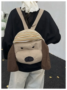 Detail of cute dog-shaped corduroy backpack featuring 3D ears and striped hat design