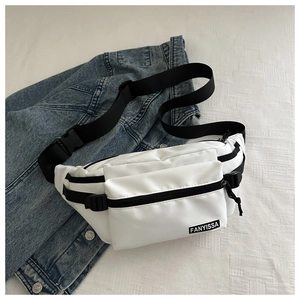 Detail of white water-resistant nylon chest bag featuring FANYISSA logo on denim jacket