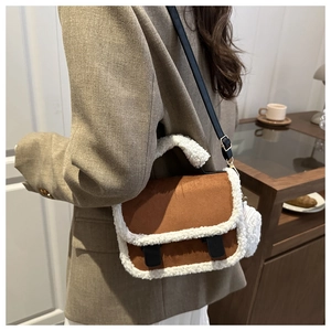 Brown frosted suede crossbody bag with plush faux fur trim shown in a cozy lifestyle setting