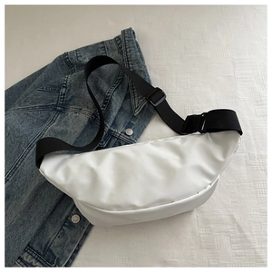 Close-up of white waterproof nylon chest bag with adjustable black strap and buckle