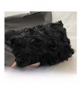 Detail of 3D chiffon floral texture on a black luxury evening clutch handbag