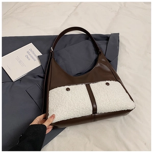 Detail of color-block plush tote bag with dark brown leather and white faux fur texture