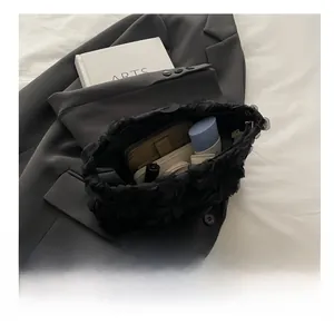 Interior view showing the large capacity of the black floral mesh tote bag with cosmetics