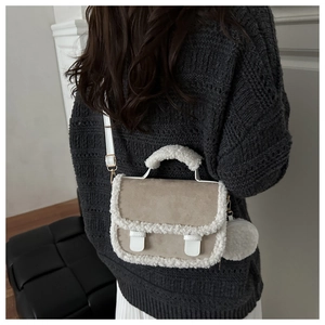 Detail of lamb wool trim crossbody bag with suede texture and mini plush coin purse