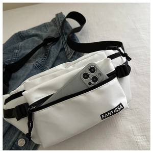 Detailed view of white nylon crossbody bag with interior space for a smartphone