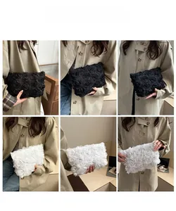 Detailed view of 3D fabric rose flower evening bags in black and white styles