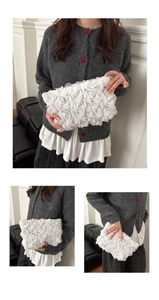 Macro detail of white mesh rose fabric and pleated layers on an elegant evening clutch