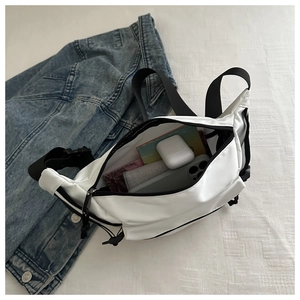 White nylon crossbody bag interior showing storage space for phone and earphones