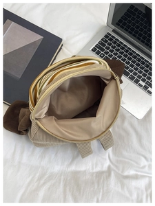Top view of corduroy backpack showing smooth light brown lining and internal storage space