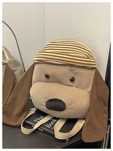 Detail view of the plush 3D dog backpack showing beige corduroy fabric and brown ears