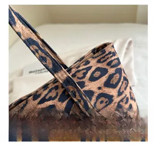 Close-up of precise stitching and premium leopard suede texture on large tote bag