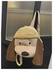 Detailed view of dog-shaped corduroy backpack featuring a cute striped knitted hat and ears