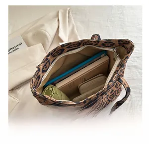 Interior view showing the large capacity and zipper closure of leopard print tote bag