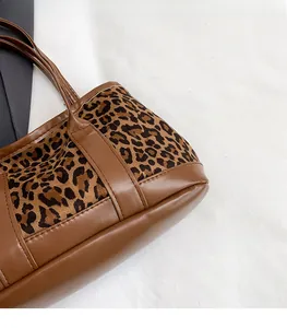 Detailed stitching on retro leopard print handbag with brown suede and leather splicing