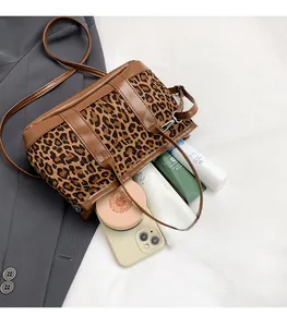 Detailed interior view of a leopard print shoulder bag showing large storage capacity