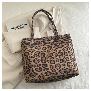Detail of trendy leopard print tote bag showing thick fabric texture and matching handles