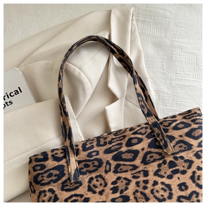 Close-up of leopard print tote bag in soft faux suede with textured shoulder straps