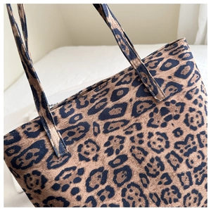 Close-up detail of leopard print tote bag fabric with matching straps for autumn style