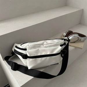 Minimalist white nylon chest bag with black zippers and adjustable strap for sports