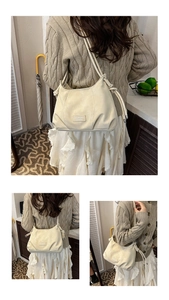 Detail of cream leather bucket bag showing unique knotted strap and front logo patch