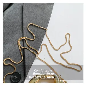 Detailed close-up of a high-gloss golden metal chain strap for evening shoulder bags