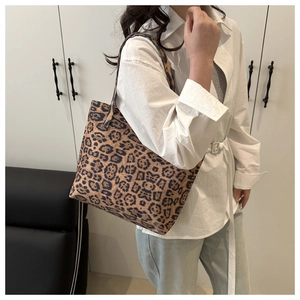 Leopard print tote bag styled with white shirt and jeans for a trendy autumn commute