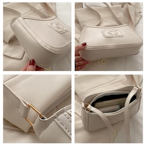 Detail view of cream PU leather underarm bag with embossed logo and adjustable strap