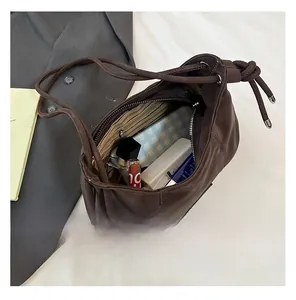 Interior view of brown leather bucket bag showing large capacity for cosmetics