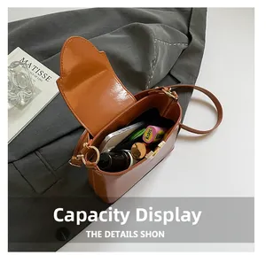 Internal storage capacity of brown vintage PU leather crossbody bag showing daily items