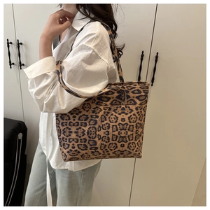 Detail of leopard print canvas tote bag featuring premium texture and sturdy shoulder straps