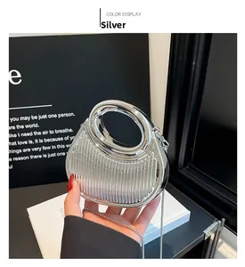 Detailed view of silver mini handbag with metallic vertical stripes and circular handle