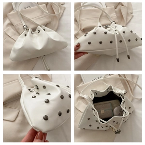 Detail shots of white studded drawstring bucket bag showing interior capacity and silver rivets