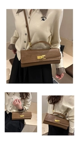 Detail of crocodile embossed crossbody bag showing handheld and shoulder styling options