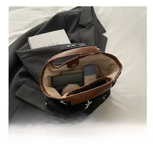 Interior view showing the large capacity and magnetic closure of the black quilted tote bag