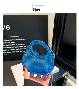 Close-up of electric blue acrylic evening bag with vertical texture and gold chain strap