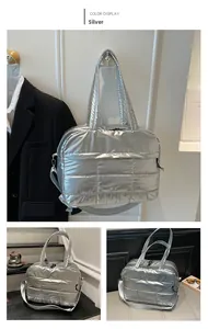 Detail view of silver quilted padded shoulder bag with dual zippers and metallic finish