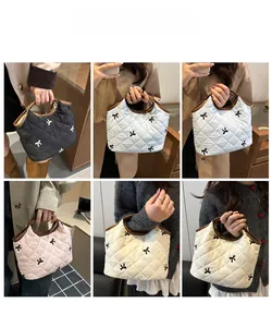 Quilted tote bags with bow embroidery and leather handles shown in multiple colors