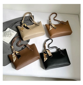 Collection of large tote bags in beige, brown, and black with decorative scarves